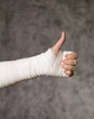 Person with bandage doing thumbs up