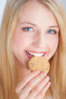 pretty blond girl with blue eyes eating cake