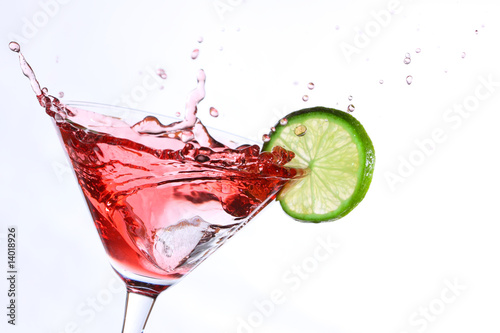 Photo : red cocktail with lime on white red cocktail with lime on white