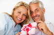 Romantic senior couple holding a gift