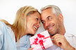 Romantic mature couple giving a gift