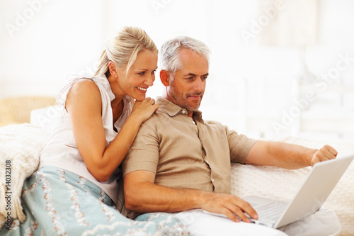 Photo: A senior retired couple working on a laptop A senior retired couple working on a laptop
