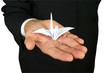 Origami bird on the hand.