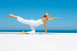 Yoga: Mature woman stretching on the beach