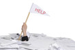 hand with help flag sticking out of desk full of paper