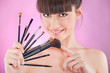 Pretty woman holding set of make up brushes Pretty woman holding set of make up brushes