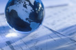 Globe with financial papers Globe with financial papers