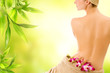Beautiful woman with naked back over green abstract background