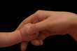 mother and baby hands on black