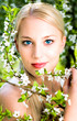 Woman by flowers on tree