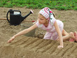 young farmer preparing vegetable bed for sowing