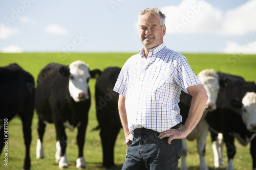 Photo: Farm Worker With Herd Of Cows Farm Worker With Herd Of Cows