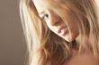 Beautiful blond girl with hair fluttering in the wind