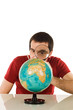 Man looking at globe