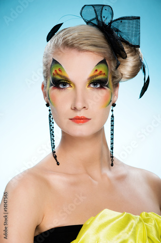 Photo: Young beauty with butterfly face-art Young beauty with butterfly face-art
