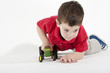 Pushing his toy tractor