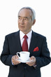 Mature businessman with teacup, cut out