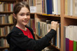 Young girl in library looking for books