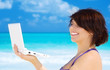 woman with laptop computer on the beach