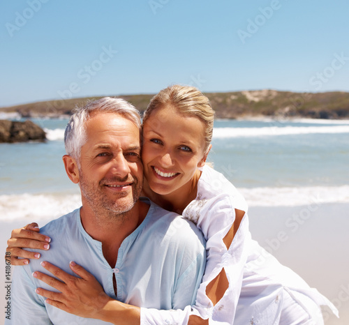 Photo: Mature couple enjoying a sunny day at the beach Mature couple enjoying a sunny day at the beach