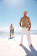 An aged old couple posing on the beach
