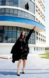 A woman throwing her graduation cap into the air