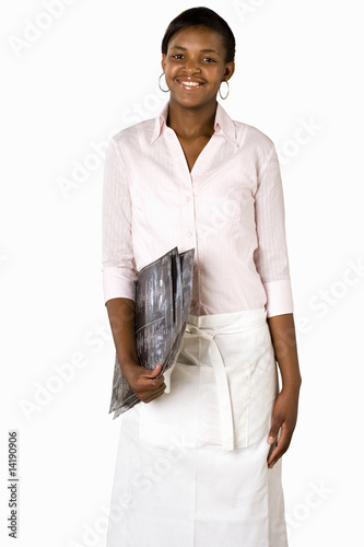 Photo: Waitress carrying menus, smiling, front view, portrait, cut out Waitress carrying menus, smiling, front view, portrait, cut out