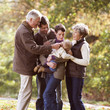 A family group standing together in autumn time