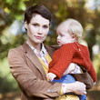 A young mother holding her baby
