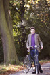 A young woman standing with her bicycle