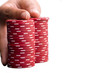 Hand on pile of gambling chips, close-up, cut out