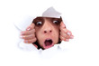woman peeking behind wall hole