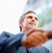 Senior business man shaking hands with a coworker