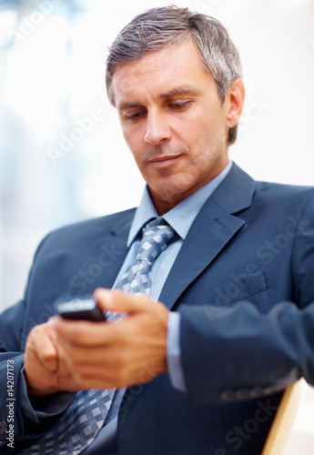Photo: Successful manger text messaging on mobile Successful manger text messaging on mobile