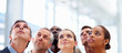 Group of business colleagues standing and looking upwards
