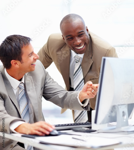 Photo: Successful businesspeople enjoying their work in the office Successful businesspeople enjoying their work in the office