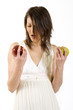 Photo: undecided woman picks an apple undecided woman picks an apple