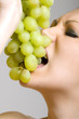 Photo: closeup of a girl biting a grape closeup of a girl biting a grape