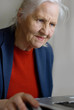 Old lady typing on laptop