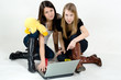 Young girls sitting on the floor with laptop