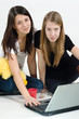 Young girls sitting on the floor with laptop