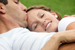 Photo: smiling woman being kissed on forehead by husband smiling woman being kissed on forehead by husband