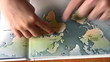 senior with child hands on map