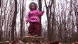 little girl jump from stub in winter park