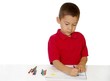 Foto: seven-year-old boy coloring with crayons seven-year-old boy coloring with crayons