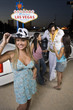 Photo: Portrait of young woman, two women with Elvis impersonator in background, Las Vegas, Nevada, USA Portrait of young woman, two women with Elvis impersonator in background, Las Vegas, Nevada, USA