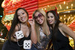 Photo: Portrait of three young women with fuzzy dice in front of illuminated casino, Las Vegas, Nevada, USA Portrait of three young women with fuzzy dice in front of illuminated casino, Las Vegas, Nevada, USA