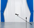 microphone on the stage with dark blue and silvery curtains
