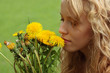 Beautiful girl in a field enjoying the sun and smelling the flow