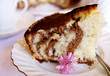 Homemade cake on a saucer decorated with a pink flower Homemade cake on a saucer decorated with a pink flower